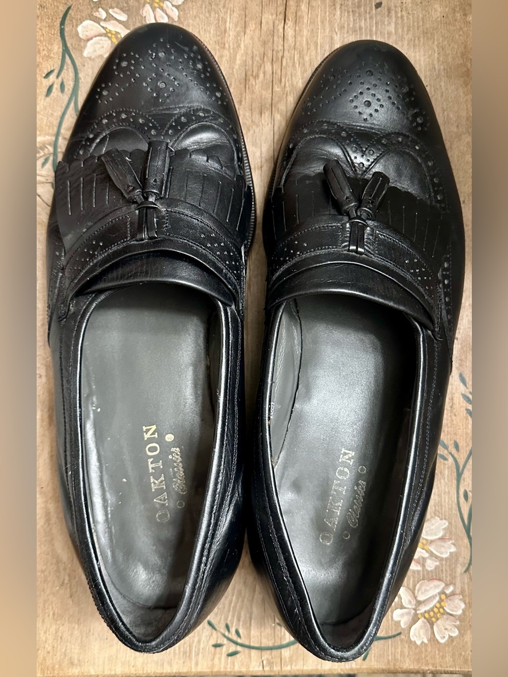 Oakton Classics black leather kiltie tasseled wingtip loafers.